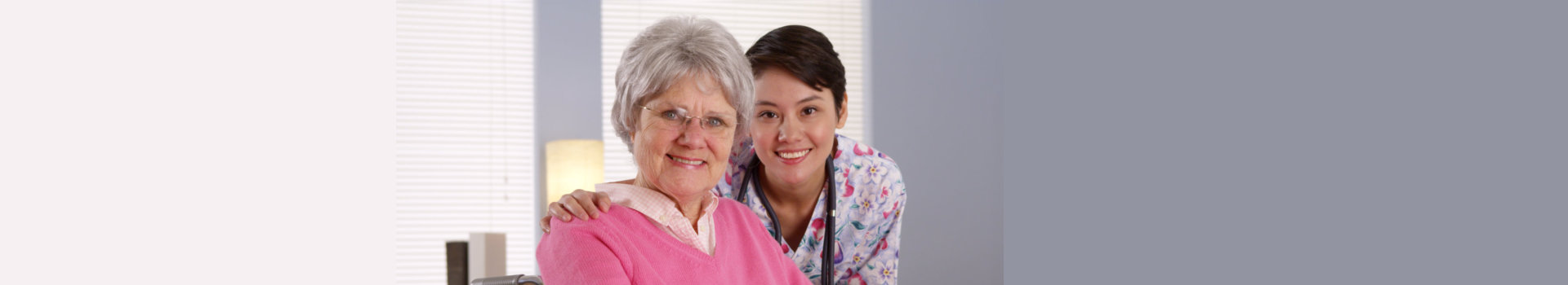 smiling caregiver and old woman